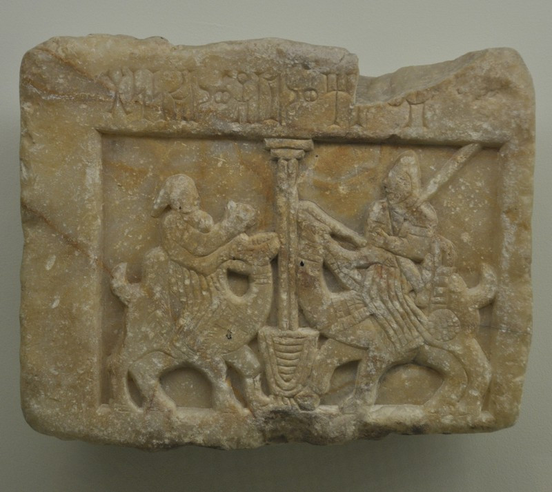 Yemenite relief of a woman and a man, seated on dromedaries, meeting at a well