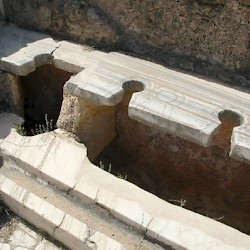 Lepcis Magna, Hadrianic baths, Western toilets (note the sculptor's error)