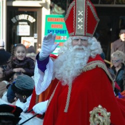 Sinterklaas arrives in Amsterdam; note that there is no Christian cross on his mitre, but the arms of Amsterdam