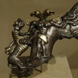 Axe in the shape of a two-headed demon, mastering a boar and a dragon (Early Bronze Age)