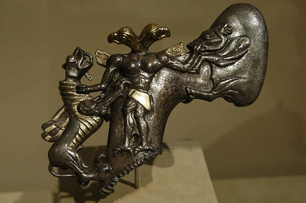 Axe in the shape of a two-headed demon, mastering a boar and a dragon (Early Bronze Age)